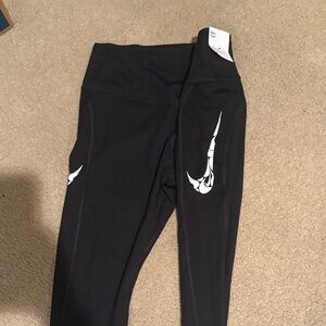 NWT Nike SIZE M Black womens Leggings with White Swoosh Graphics